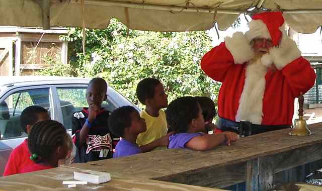 In this photo, Santa prepares to talk to children grouped around him
