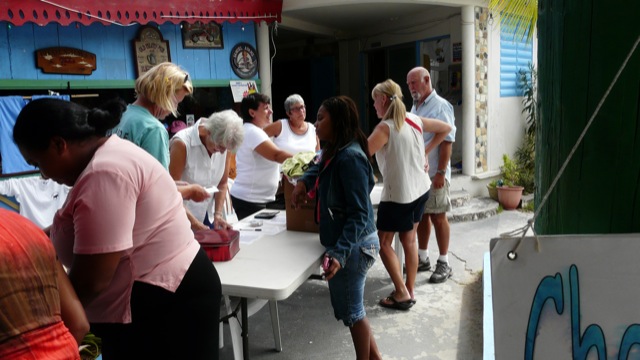 After selecting their goods, there is a fast and easy checkout line This photo shows people participating in one of our yard sales