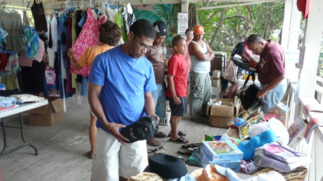 There is a large section with toys and games This photo shows people participating in one of our yard sales