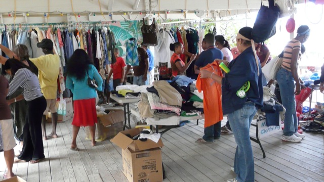 Shoppers enjoy a relaxed setting with a a oovered roof and the goods are all organized neatly This photo shows people participating in one of our yard sales