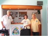 Gary and Barbara show the goodies they brought to the shelter, while Suzie looks on