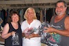 Annie, Suze and Marvin hold supplies they brought in their luggage